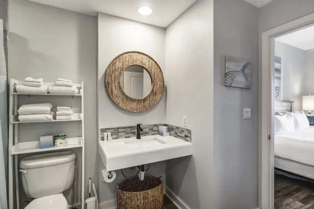 a bathroom with a sink a toilet and a mirror