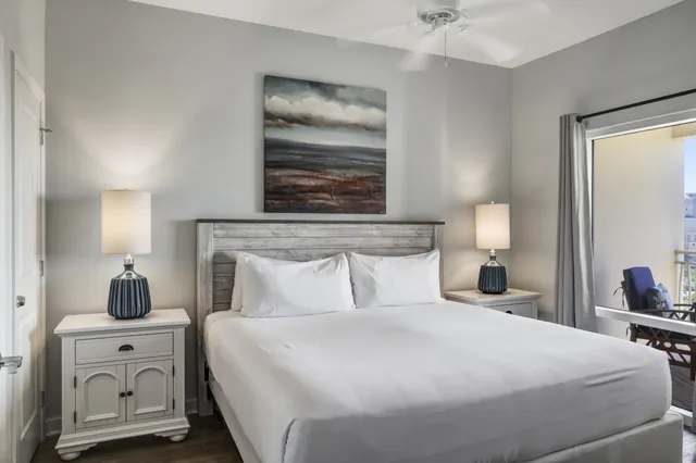 a hotel room with flat screen tv and a lamp
