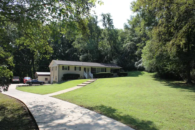 a view of a house with swimming pool and yard