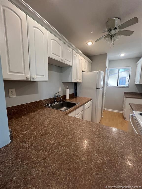 5335 Southeast Miles Grant Road, Unit 214 Stuart, FL 34997 - Photo 6 of 17 a view of kitchen with stainless steel appliances granite countertop a refrigerator a stove a sink and a cabinets