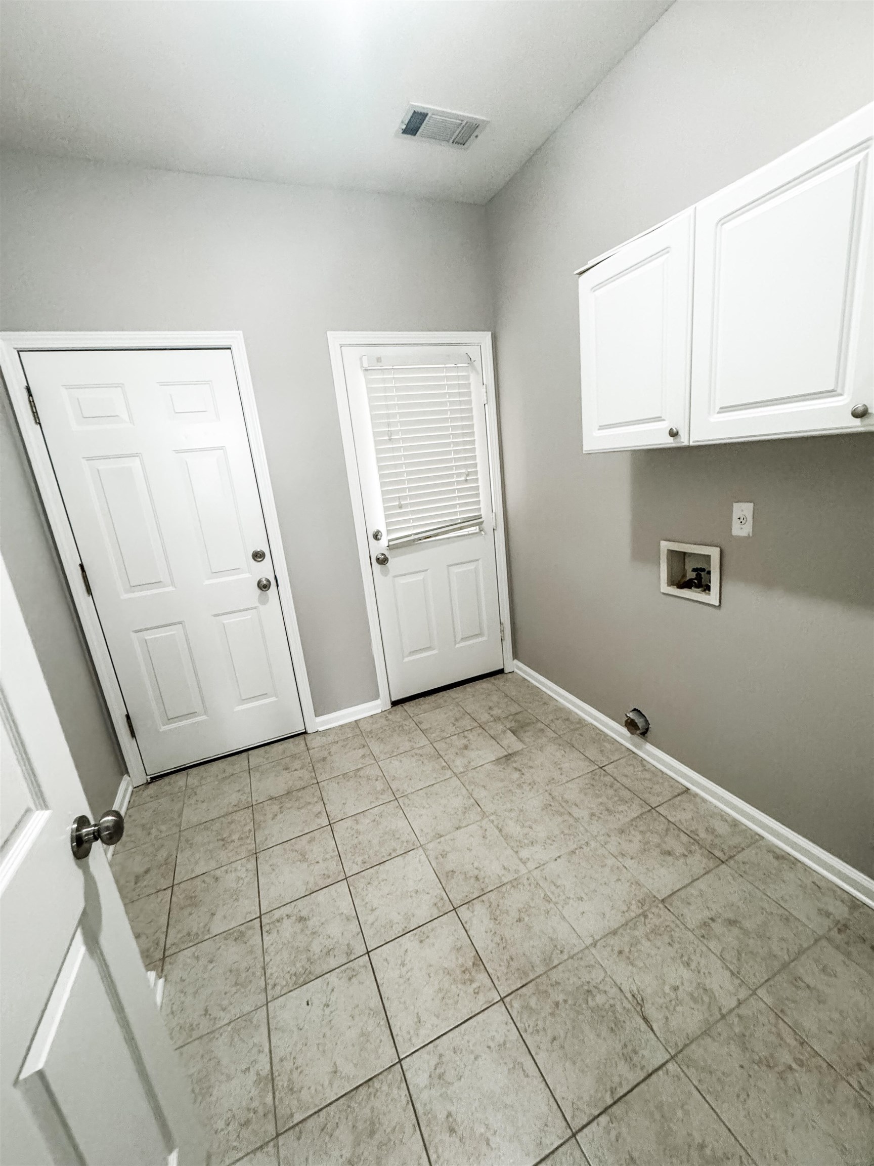 4564 Park Ridge Parkway Collierville, TN 38017 - Photo 11 of 12 Laundry room featuring hookup for a washing machine, light tile patterned floors, and cabinet space