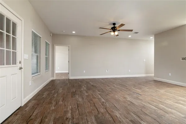 wooden floor in an empty room with a window