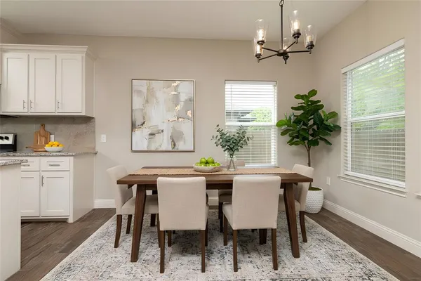 a view of a dining room with furniture window and wooden floor