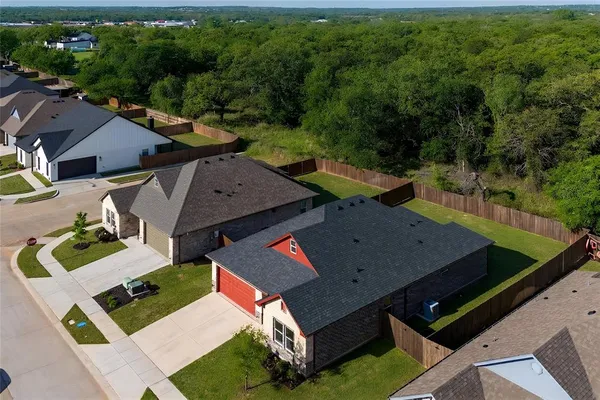 an aerial view of residential houses with outdoor space