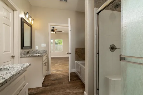a bathroom with a granite countertop sink and a mirror