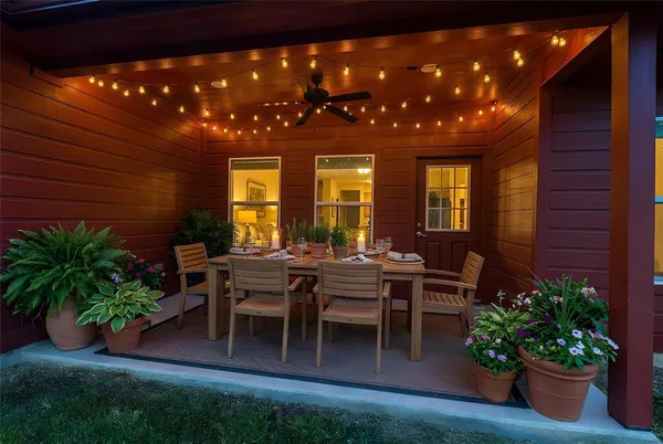 a view of a porch with chairs and potted plants