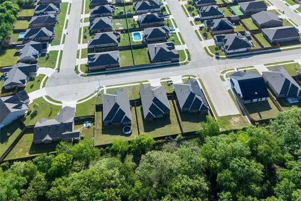 an aerial view of multiple houses with yard