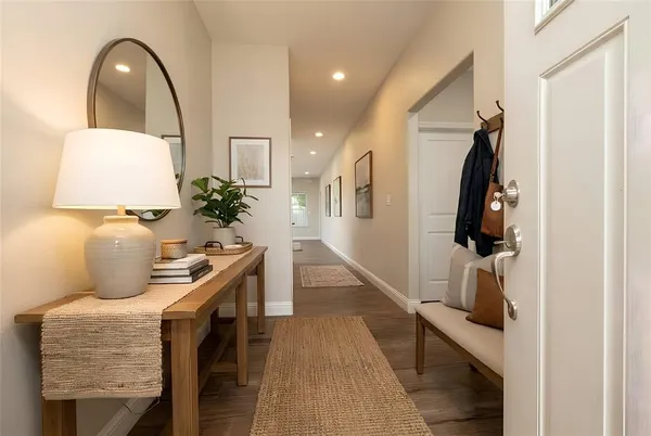 a living room with furniture and a potted plant