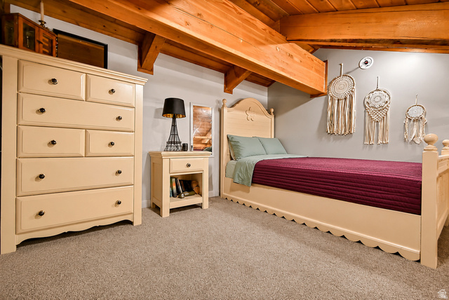 544 East 600 North, Unit 1 Joseph, UT 84739 - Photo 22 of 65 Exposed wood beams complement the neutral wall color in this room featuring a carpeted floor, built-in ceiling light, and a dedicated wall outlet