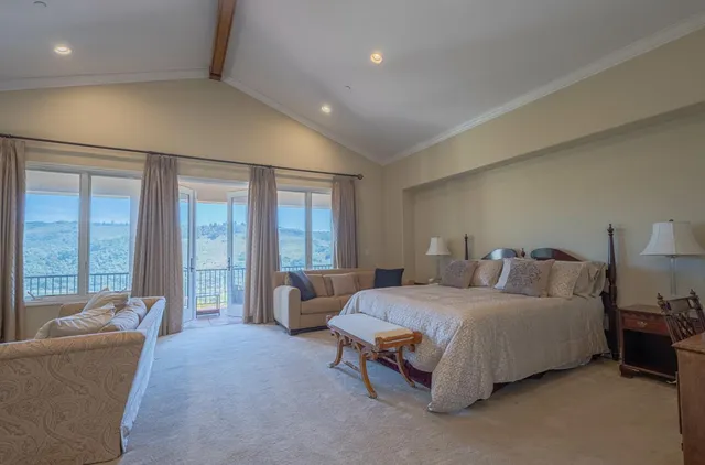 a view of a terrace with lawn chairs