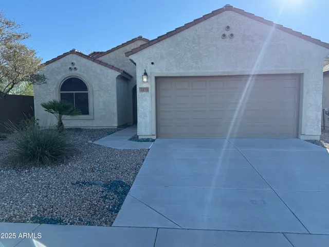 a view of a grey house with a yard