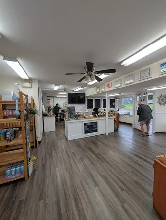 a living room with lots of furniture and kitchen view