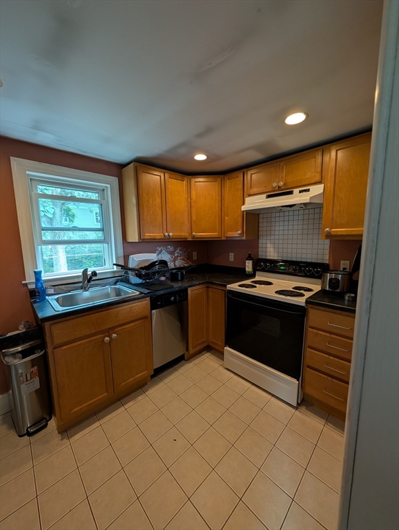 57 East Street Ipswich, MA 01938 - Photo 13 of 25 a kitchen with granite countertop a stove a sink and a microwave