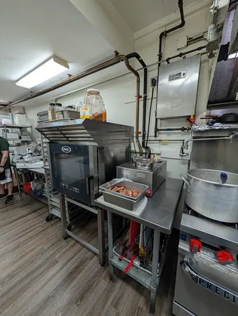 a kitchen with stainless steel appliances granite countertop a stove and white cabinets