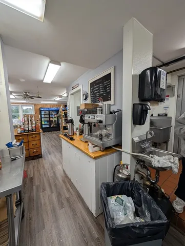 a kitchen with stainless steel appliances a sink a stove and a table