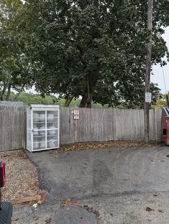 a view of a backyard with wooden fence