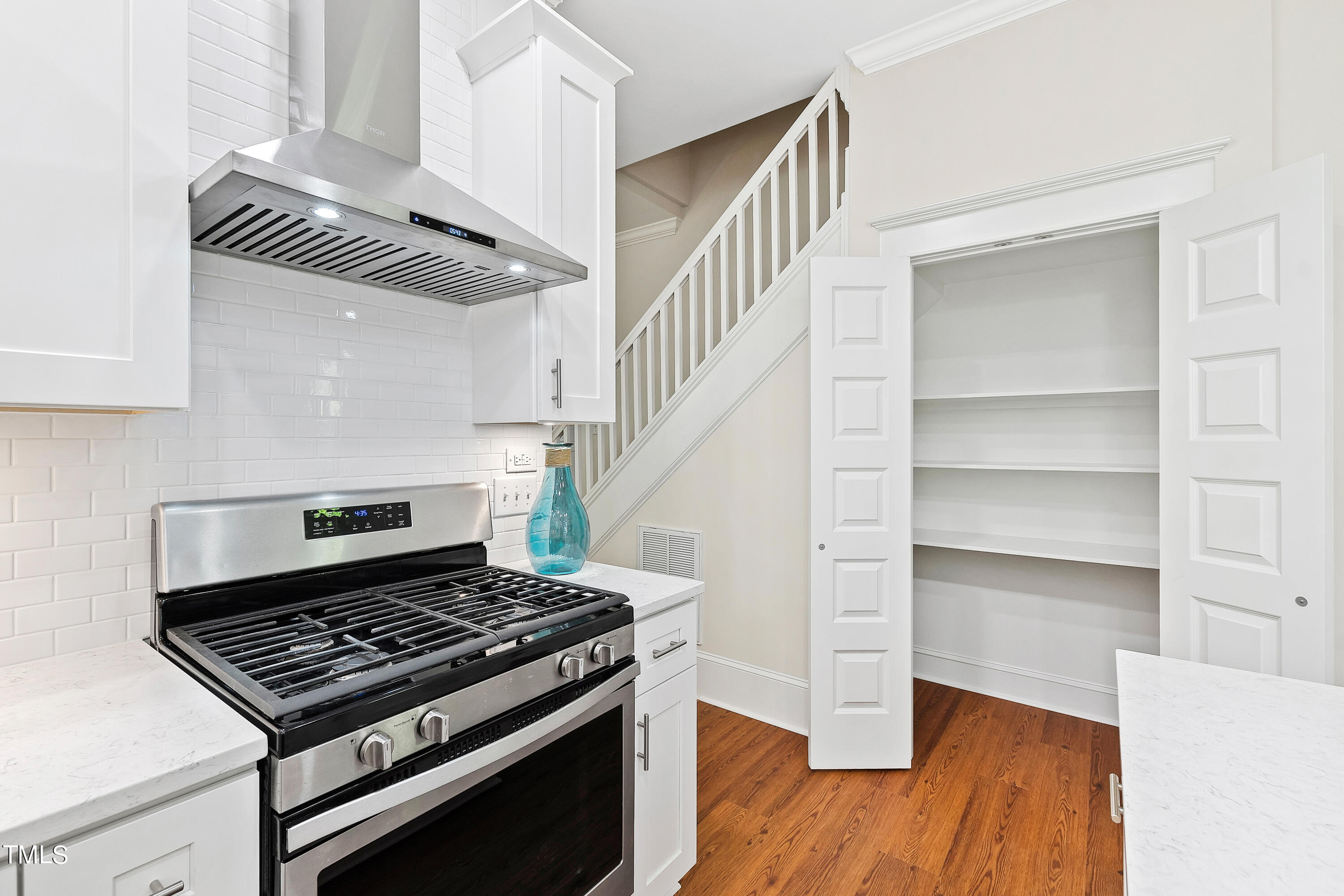 1803 Fairview Road Raleigh, NC 27608 - Photo 16 of 49 a kitchen with a stove and a wooden floor