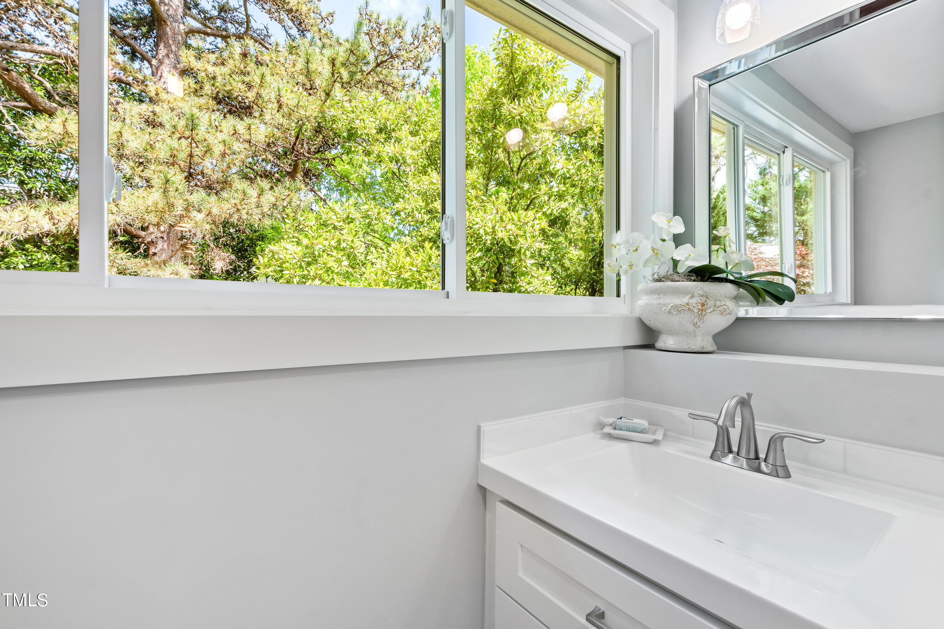 1803 Fairview Road Raleigh, NC 27608 - Photo 25 of 49 a bathroom with a sink and a window