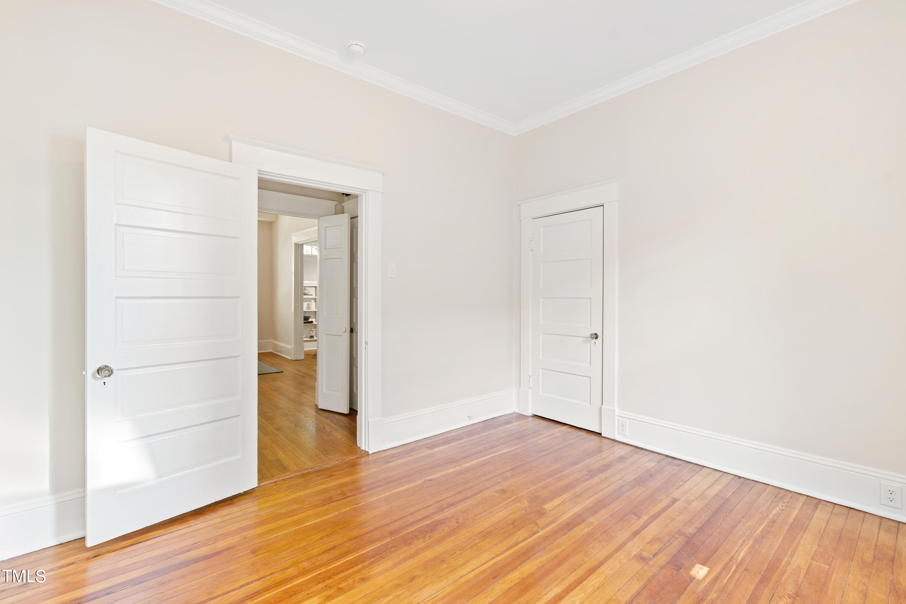 1803 Fairview Road Raleigh, NC 27608 - Photo 28 of 49 an empty room with wooden floor and entrance