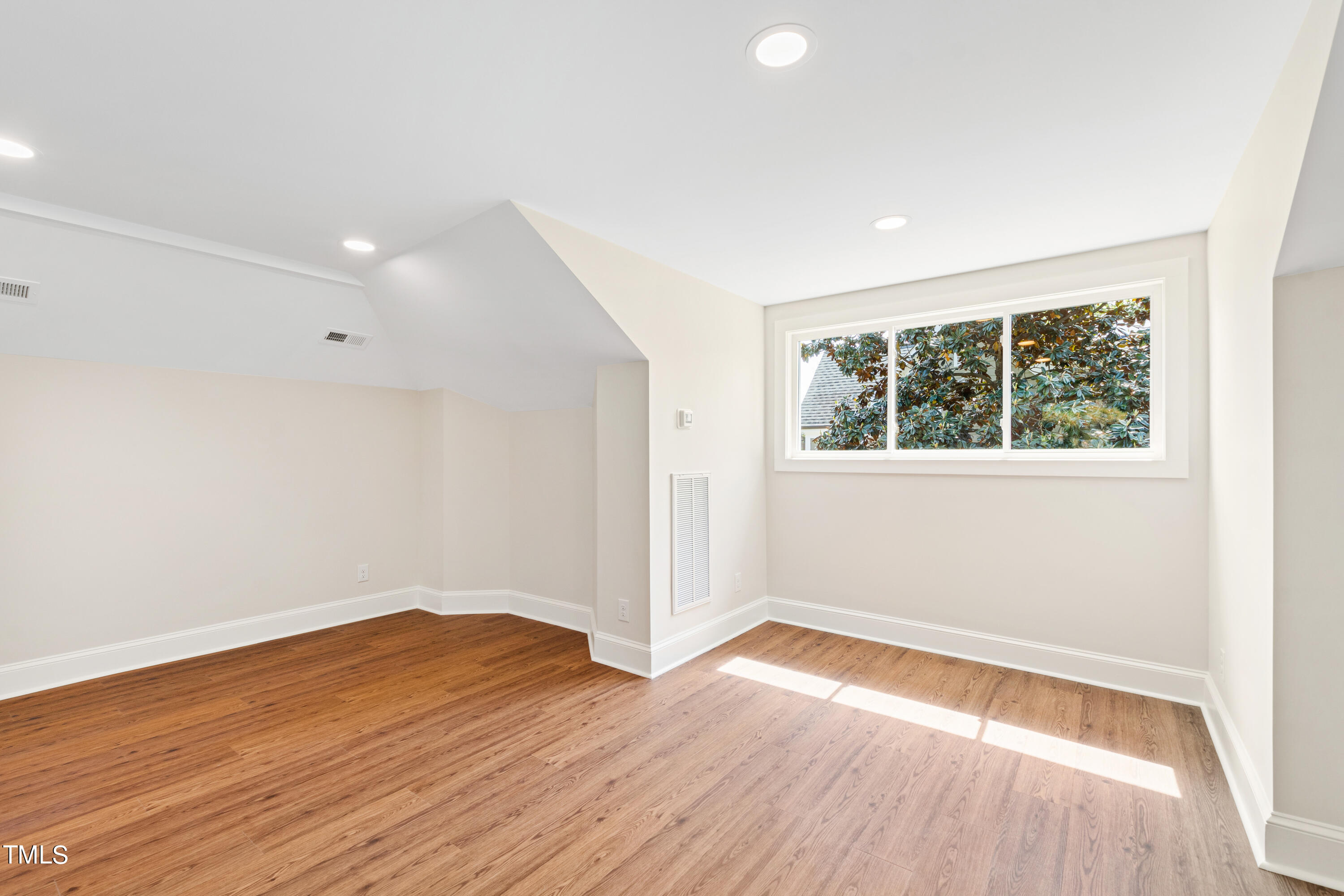 1803 Fairview Road Raleigh, NC 27608 - Photo 30 of 49 an empty room with wooden floor and windows