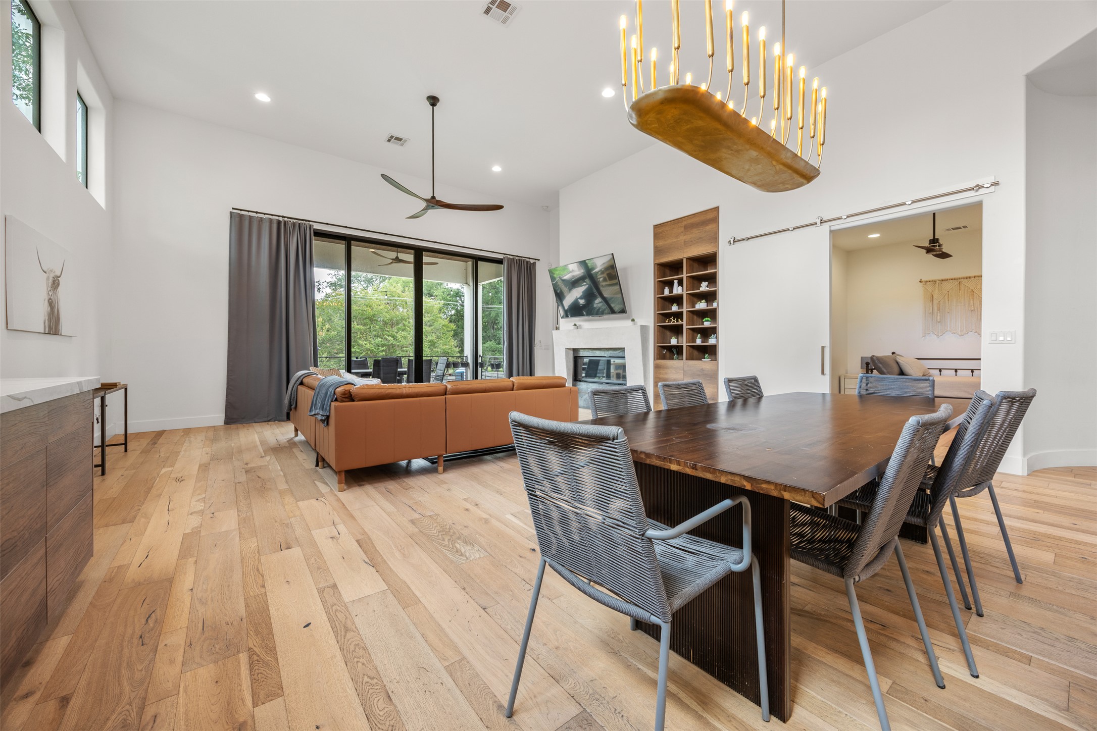 4103 Ridgelea Drive Austin, TX 78731 - Photo 10 of 26 Blonde hardwood floors flow through this luminous great room with a dramatic, vaulted ceiling and sleek fireplace.