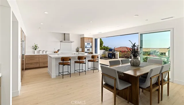 a living room with furniture a large window and a wooden floor