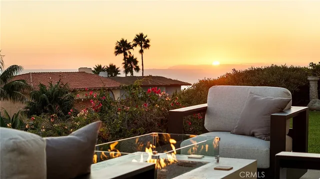 a view of a house with sitting area and garden