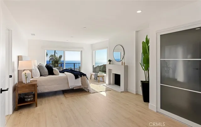 a bedroom with a large bed and a potted plant