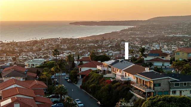 a view of a patio with couches table and chairs potted plants with sky view