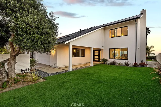 a view of a dry yard with wooden fence