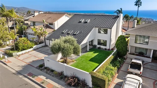 an aerial view of a houses with a lake view
