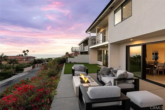 a view of a house with backyard sitting area and garden