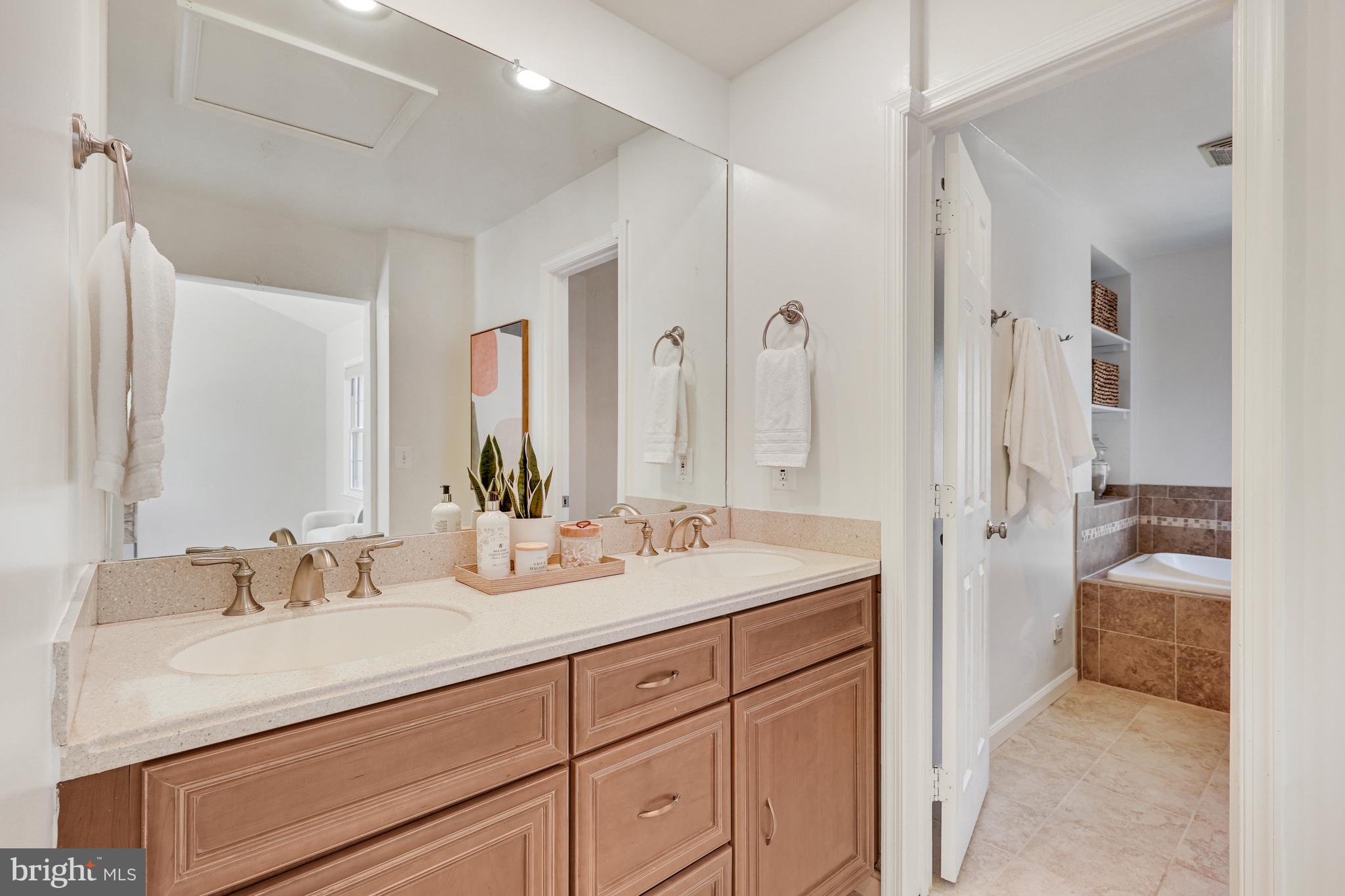 1807 Post Oak Trail Reston, VA 20191 - Photo 37 of 79 a bathroom with a sink double vanity and a shower