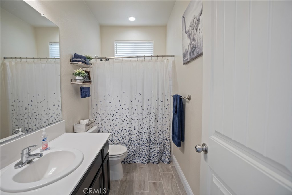 4440 Lindsey Lane Merced, CA 95348 - Photo 14 of 23 a bathroom with a sink a mirror and a shower