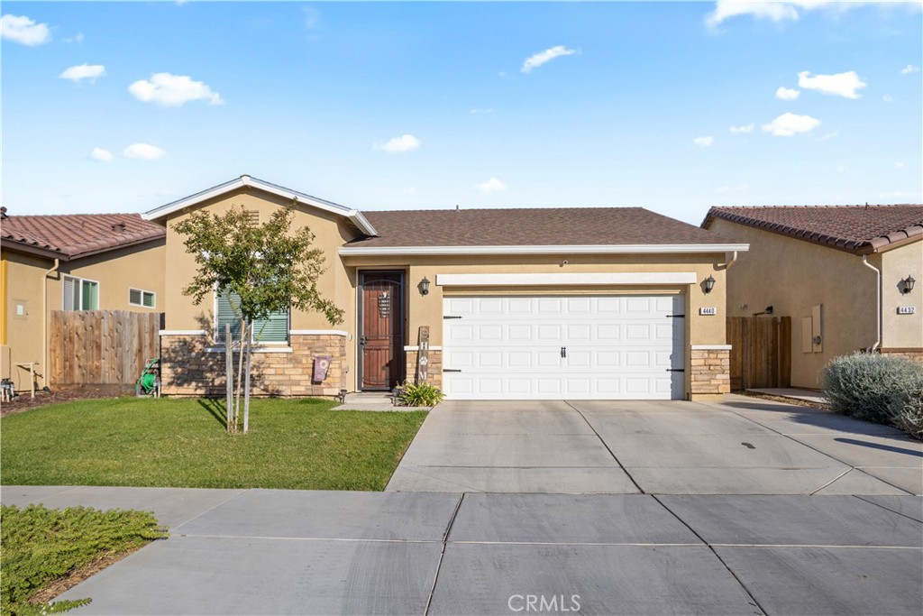 4440 Lindsey Lane Merced, CA 95348 - Photo 2 of 23 a front view of a house with a yard and garage