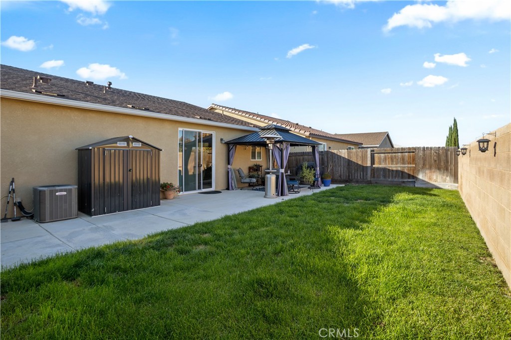 4440 Lindsey Lane Merced, CA 95348 - Photo 22 of 23 a view of a house with a backyard and a patio