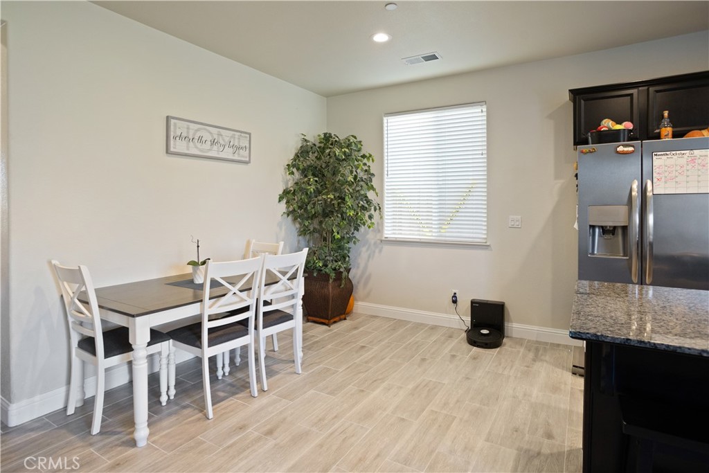 4440 Lindsey Lane Merced, CA 95348 - Photo 5 of 23 a view of a dining room with furniture and wooden floor
