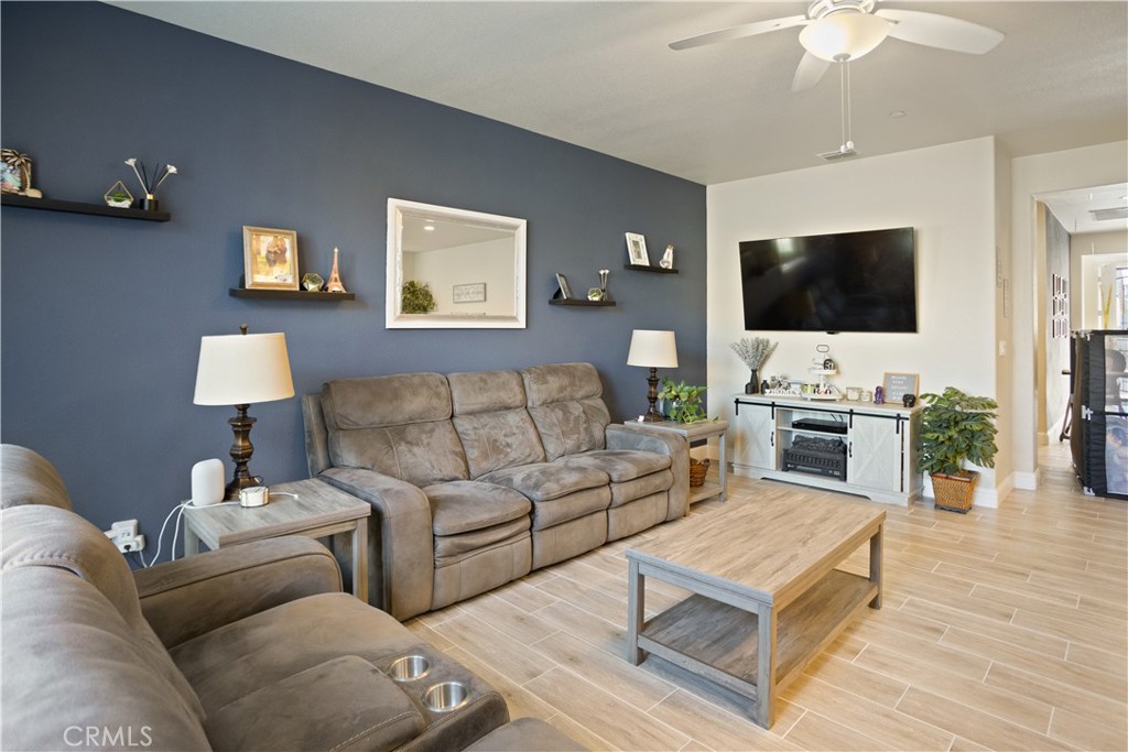 4440 Lindsey Lane Merced, CA 95348 - Photo 10 of 23 a living room with furniture a flat screen tv and a fireplace