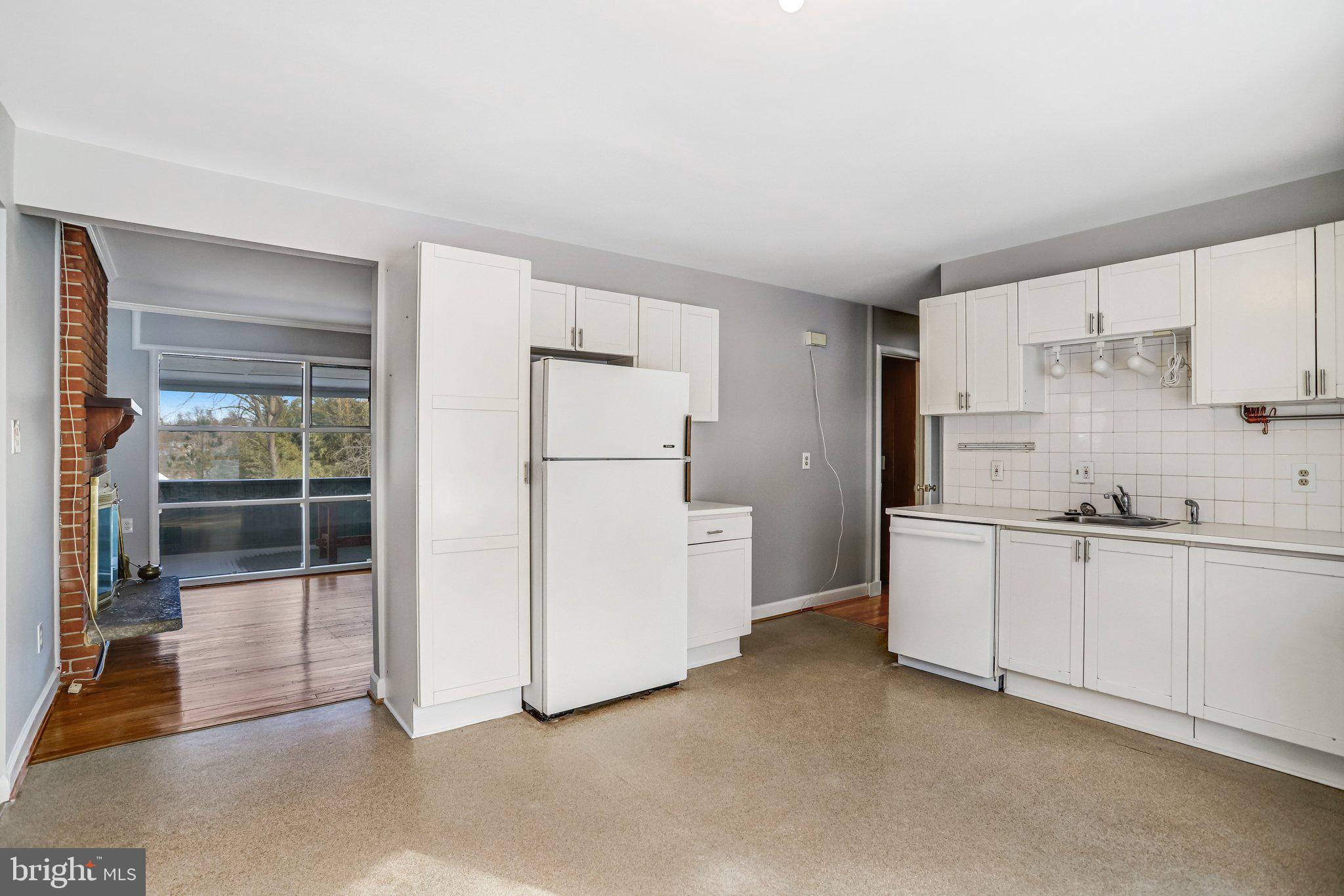 841 Bowie Road Rockville, MD 20852 - Photo 5 of 18 a kitchen with white cabinets and white appliances