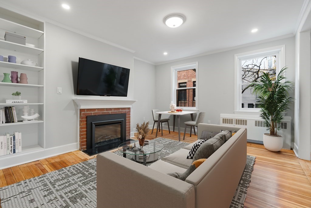 a living room with furniture a fireplace and a flat screen tv