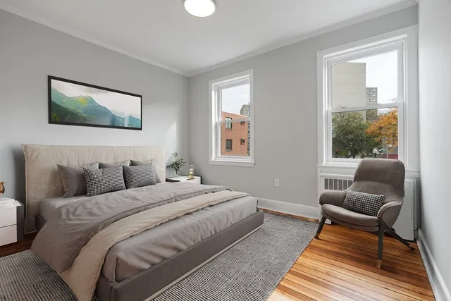 a bedroom with a bed and wooden floor