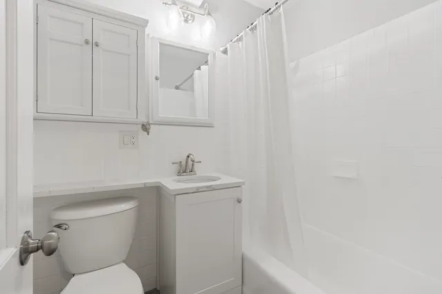 a bathroom with a toilet a sink and bathtub