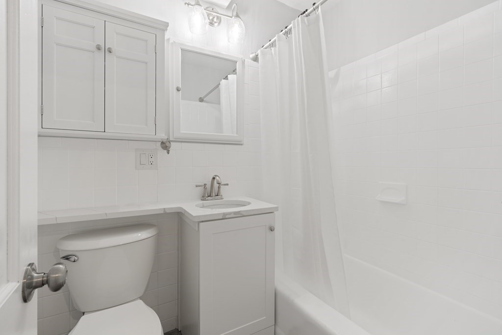 12 Fayette Street, Unit 2 Boston, MA 02116 - Photo 6 of 8 a bathroom with a toilet a sink and bathtub