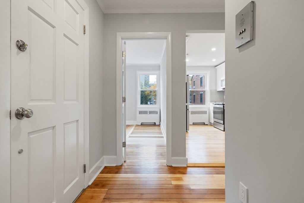 12 Fayette Street, Unit 2 Boston, MA 02116 - Photo 7 of 8 a view of a hallway with wooden floor and glass door