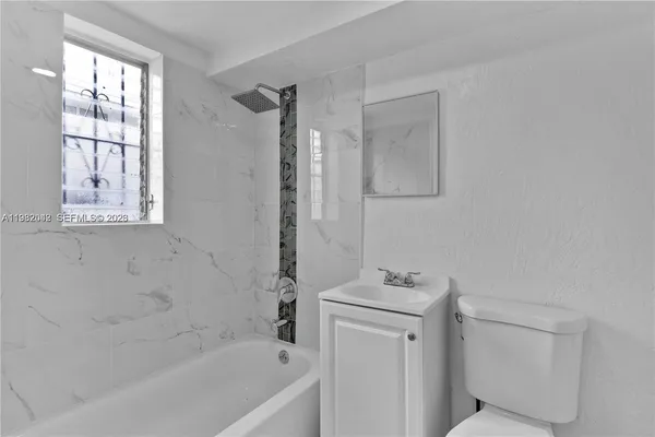 an aerial view of a city with lots of residential buildings and mountain view in back