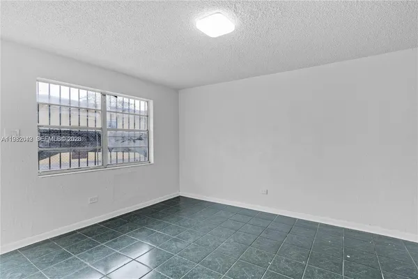 a white bath tub sitting next to a white sink and vanity