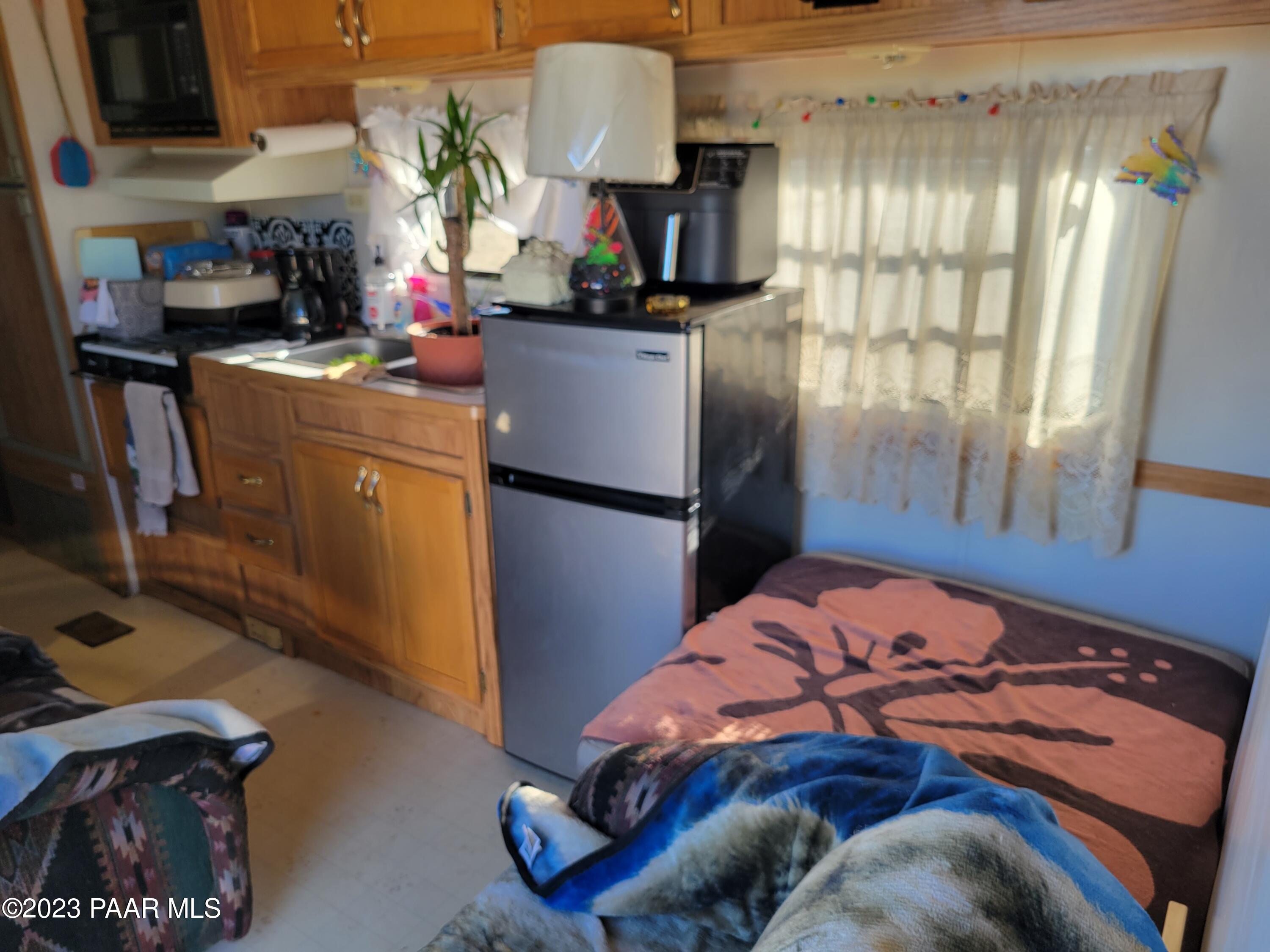 103 B Antelope Run Road Seligman, AZ 86337 - Photo 6 of 17 a bedroom with a bed and a tv in it
