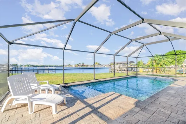 a view of a swimming pool with an outdoor seating space