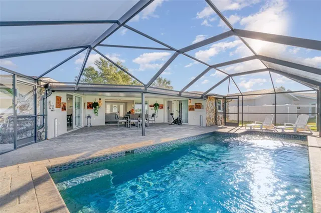 a view of a patio with table and chairs under an umbrella