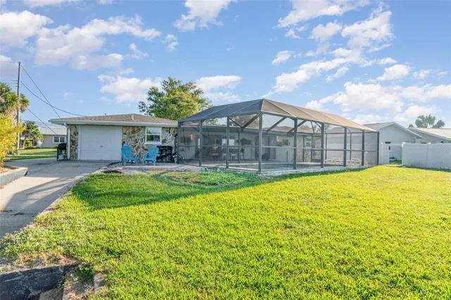 a swimming pool with outdoor seating and yard
